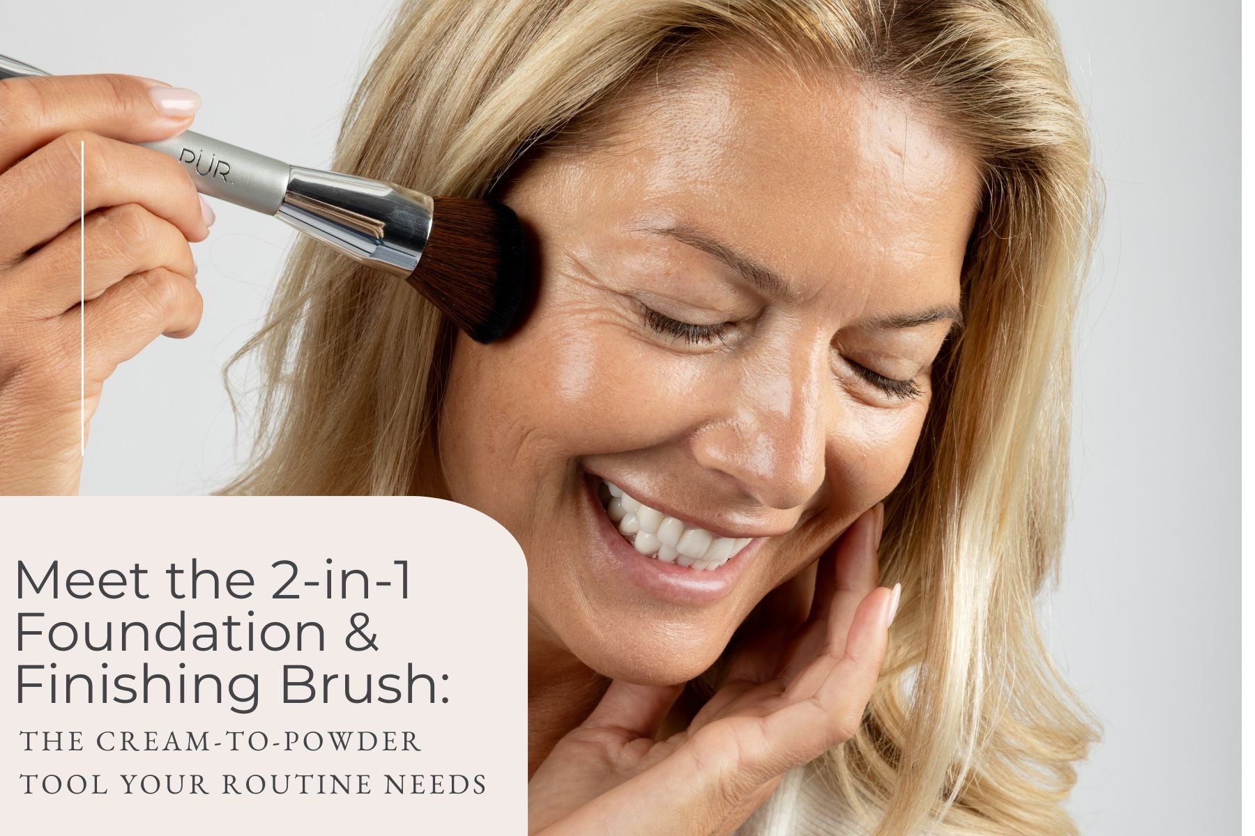 Smiling woman having makeup applied to her cheek with a fluffy foundation brush.