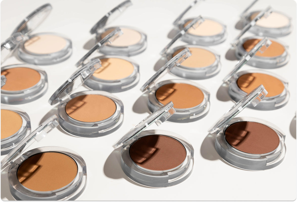 Free Mystery Bag on Orders $60+: Open Pressed Mineral Makeup in various shades lined up against white background