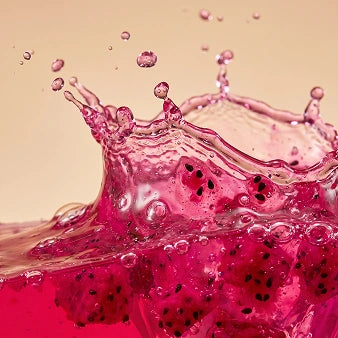 Key Ingredients - Dragon Fruit Extract: Dragon fruit in pink liquid splashing against neutral background