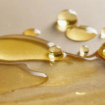 Key Ingredients - Ginseng Extract: Golden serum against neutral background