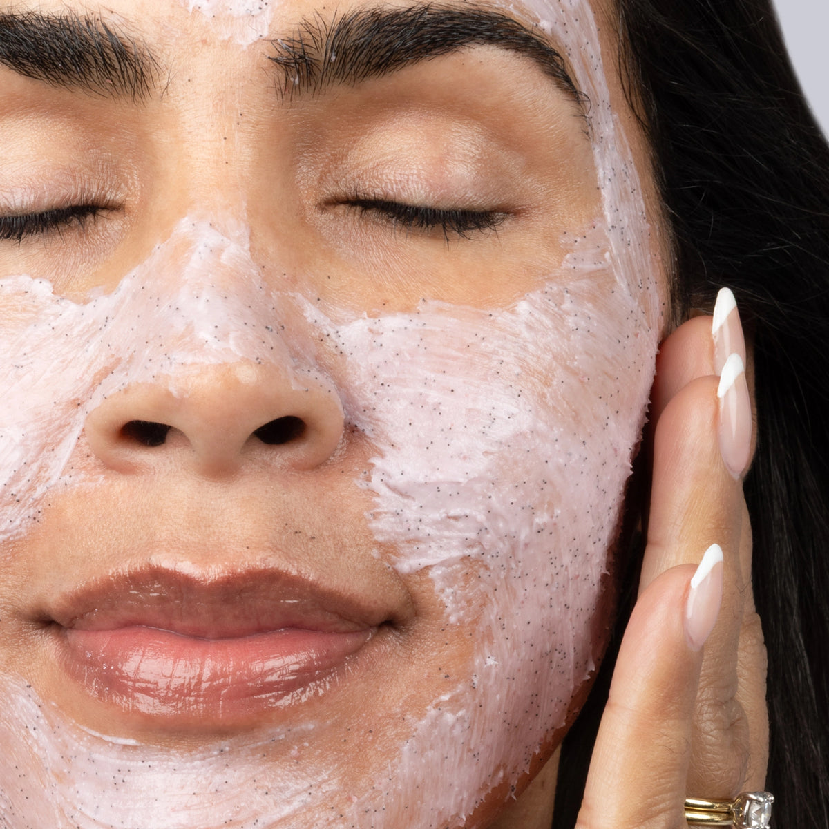 Polish & Radiate Exfoliating Dragon Fruit Mask - woman applying mask