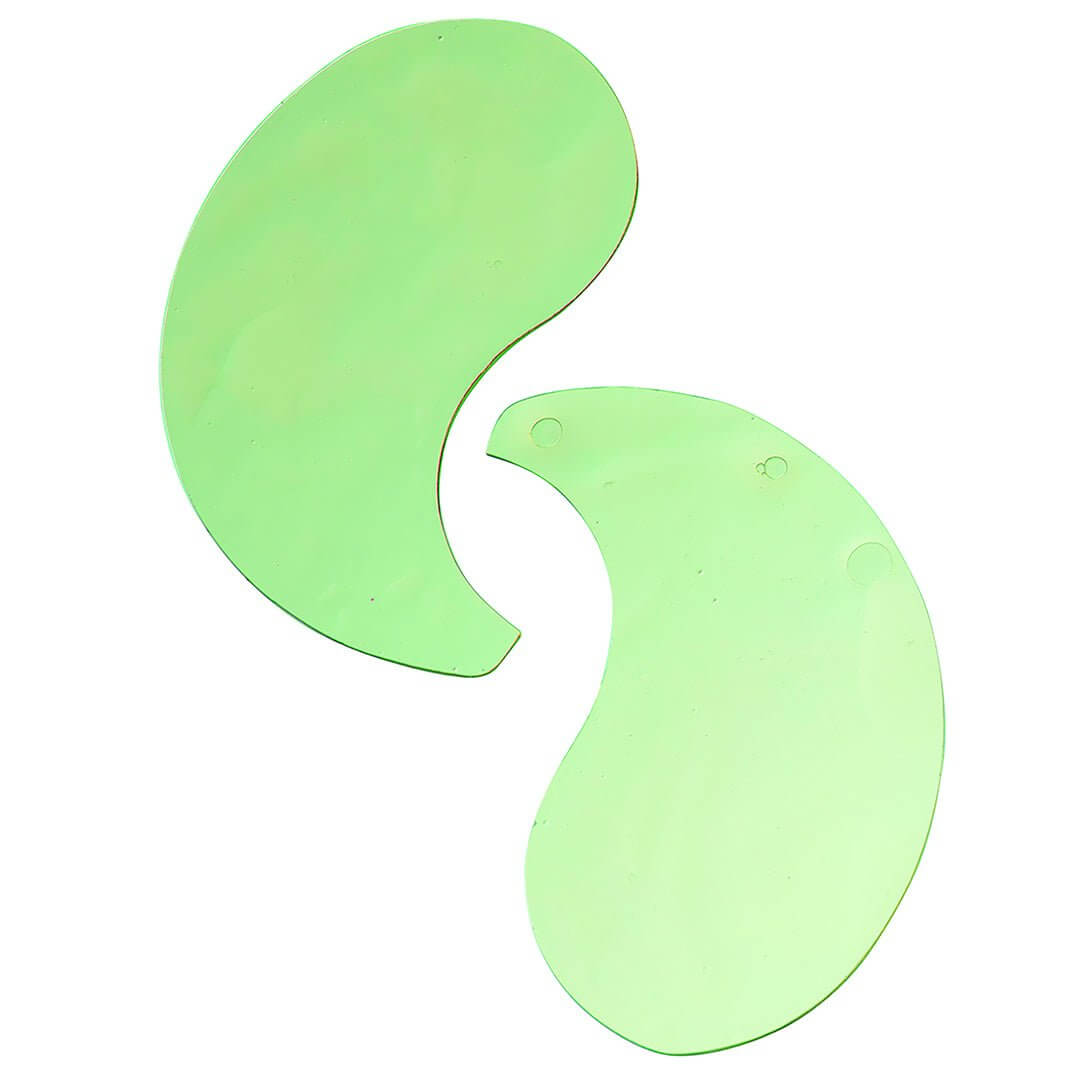 Two green hydrogel eye patches on a clean white background to show size and curved design.